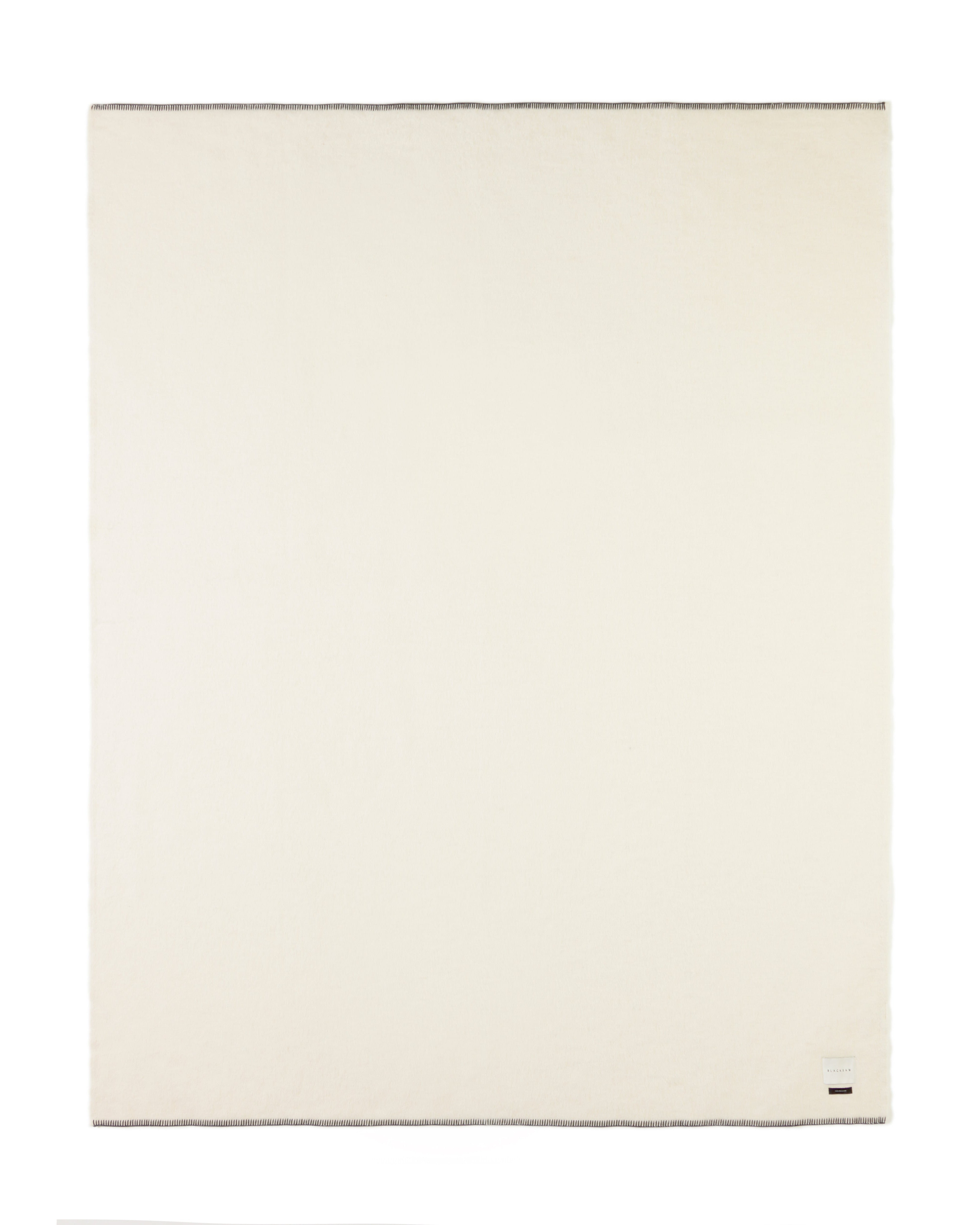 ivory blacksaw blanket with black stitch on a white background