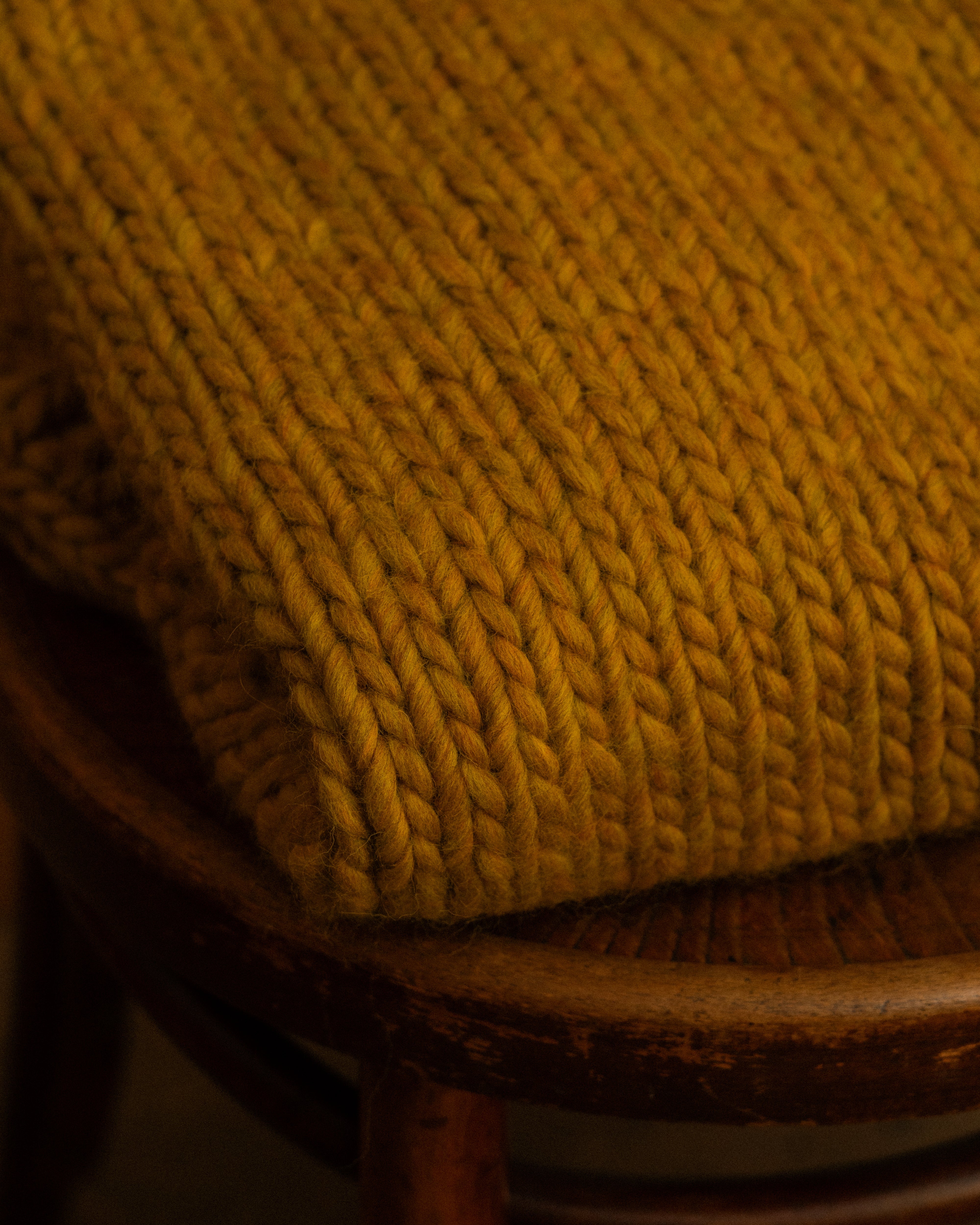 close-up of ochre merino wool knit crewneck by Diane Rudge