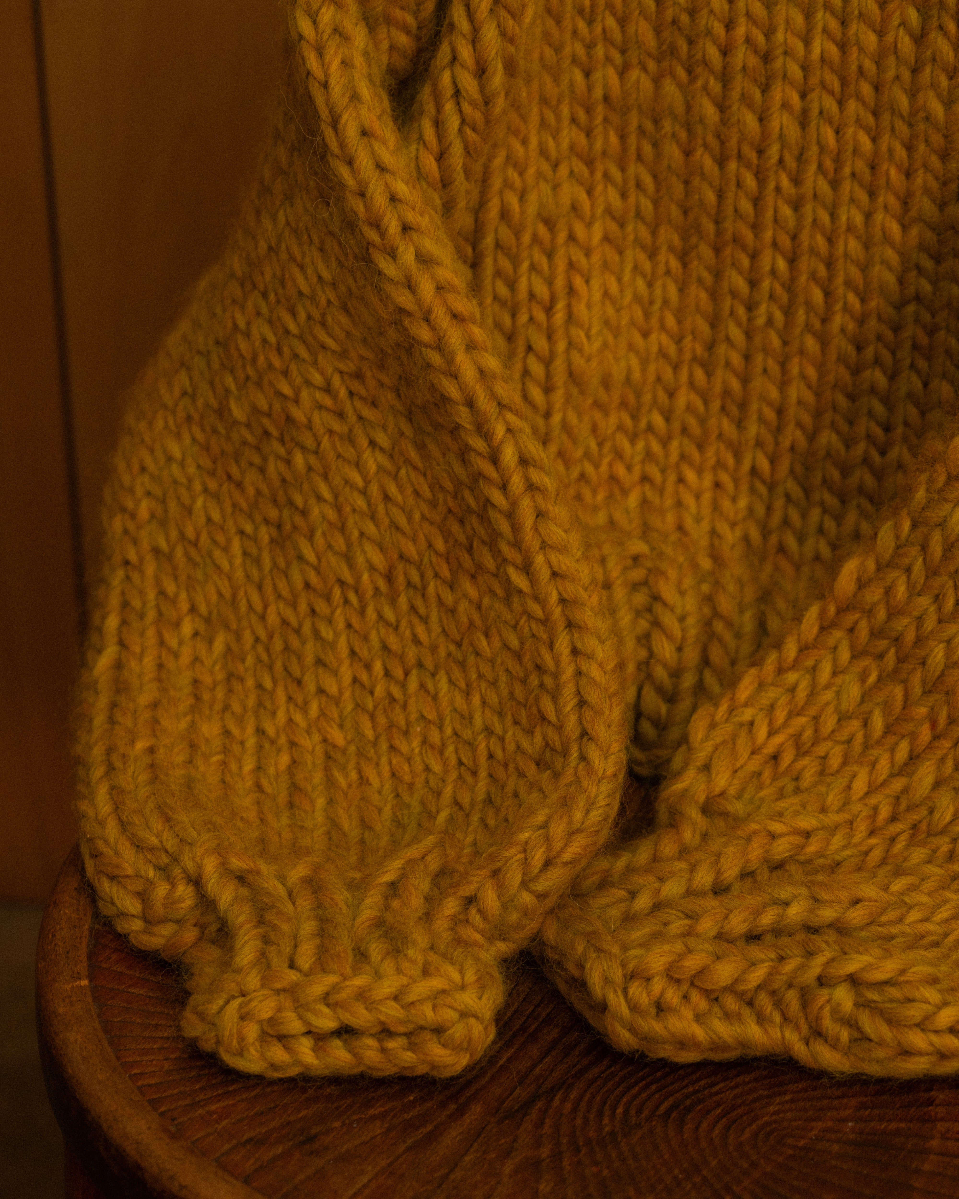 Sleeve detail of ochre merino wool knit crewneck by Diane Rudge