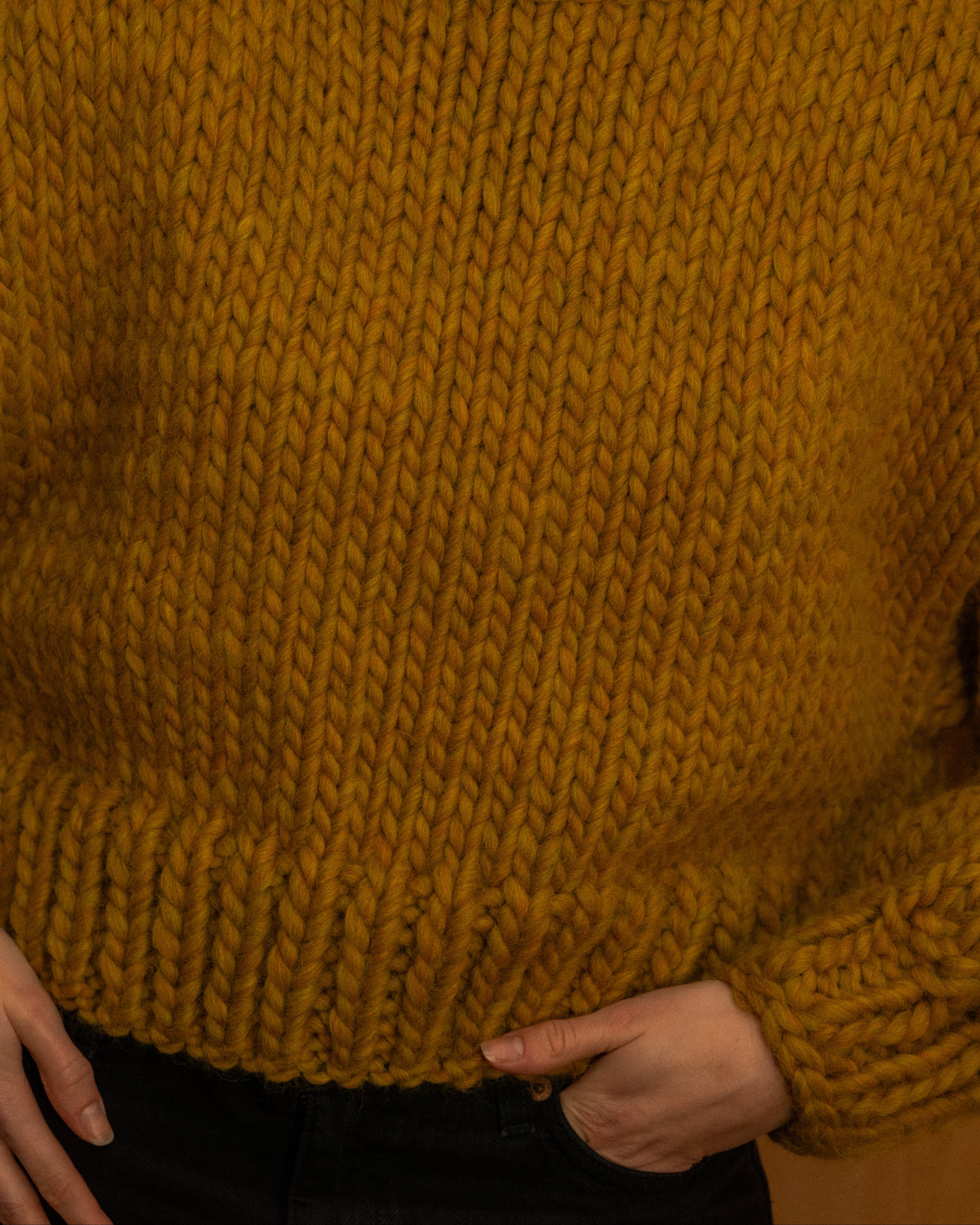 Woman wearing an ochre merino wool knit crewneck by Diane Rudge