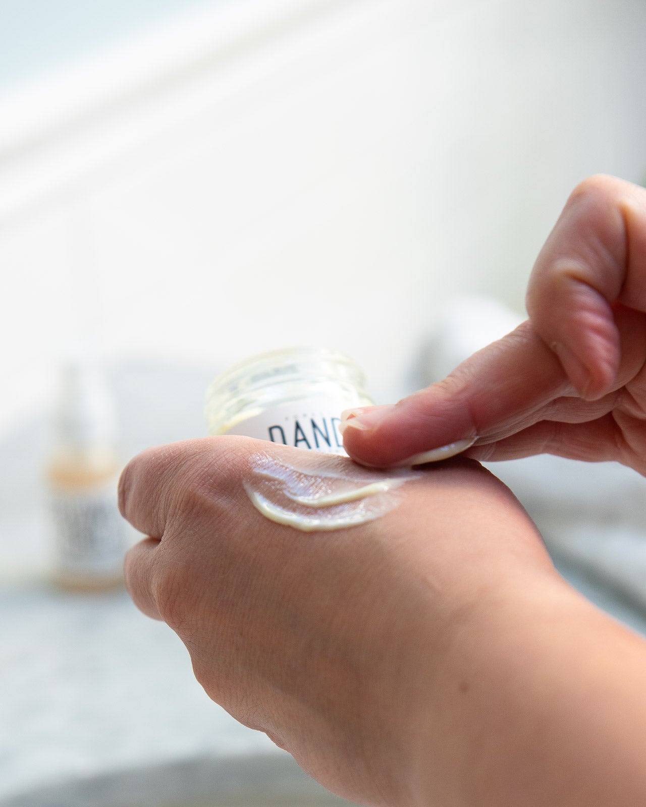 model applying dandelion moisturizer