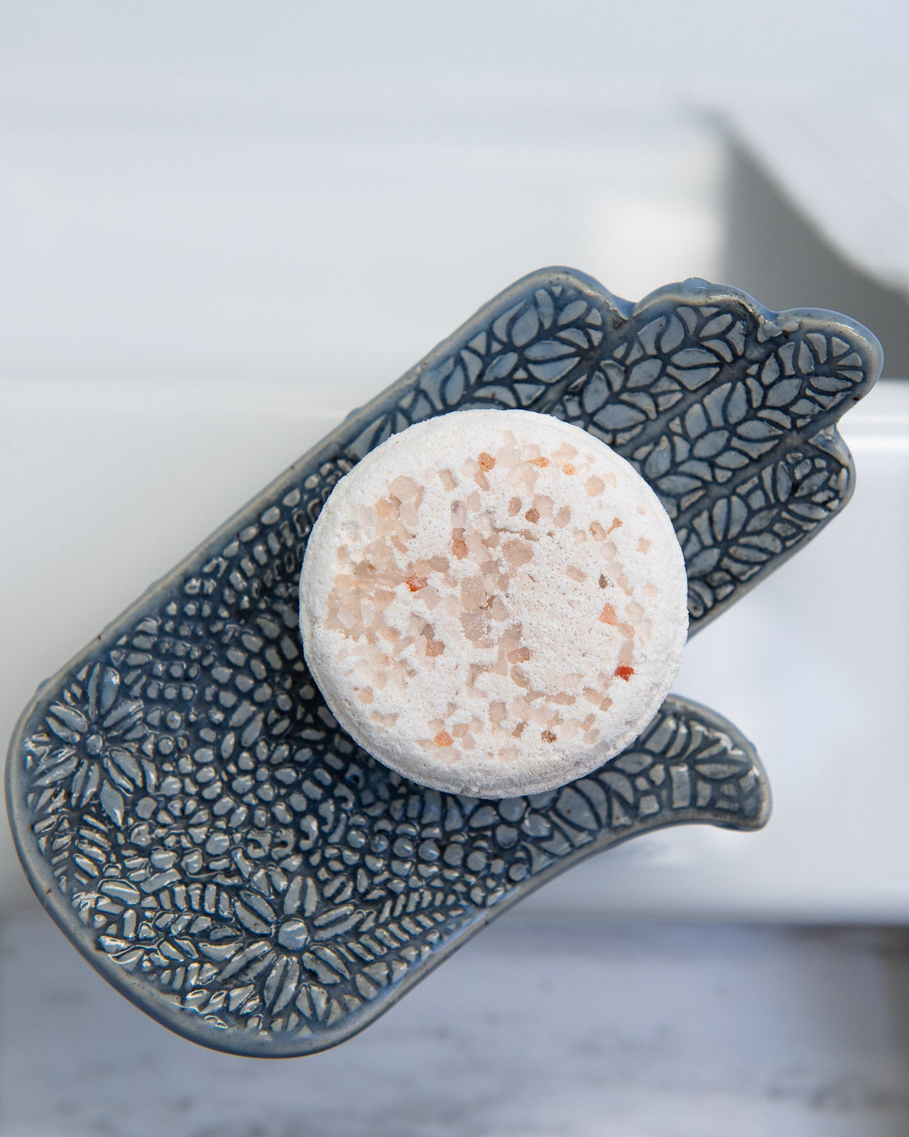 soap dish with resh bath bomb on it