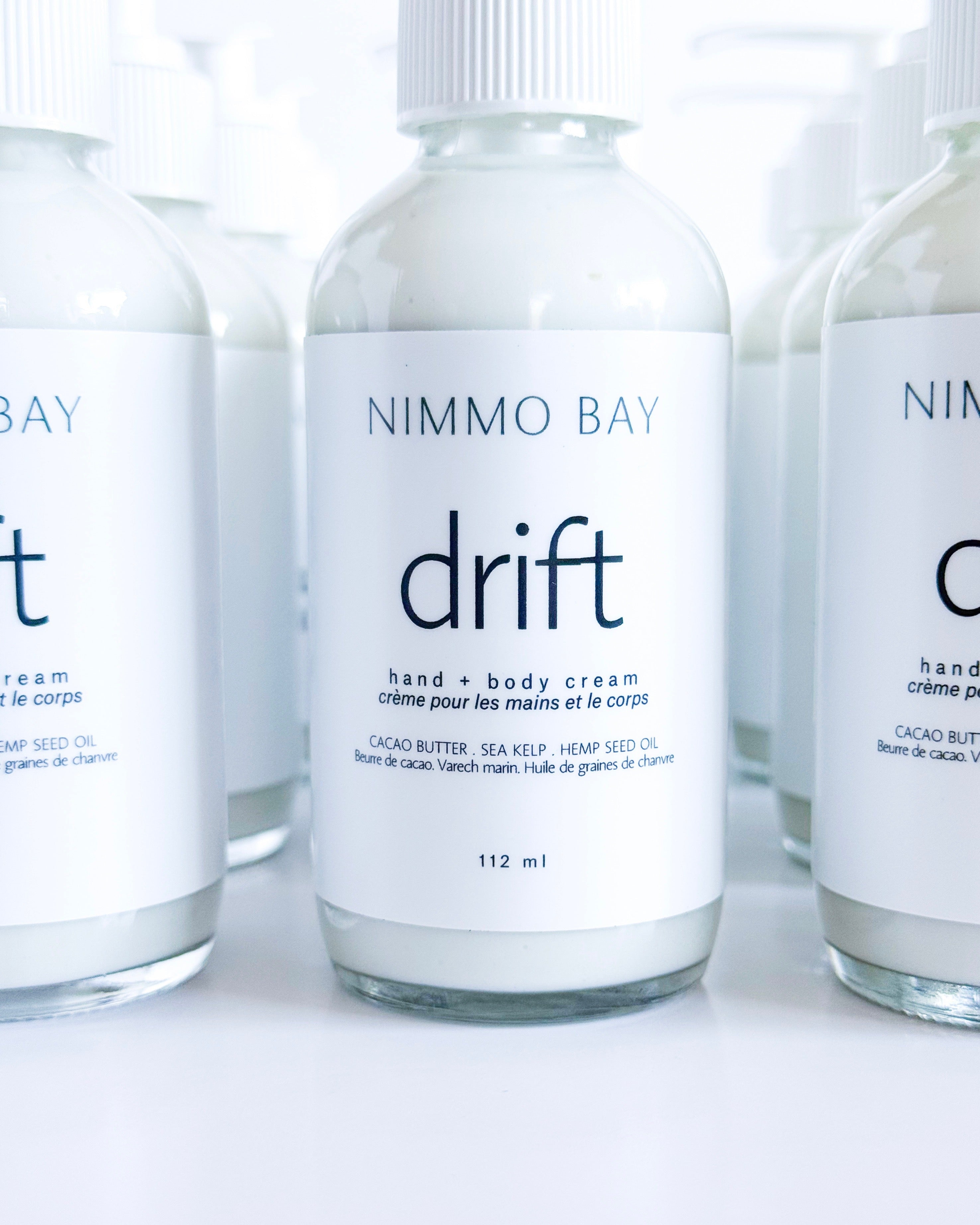 Nimmo Bay drift hand and body cream bottles on a white background