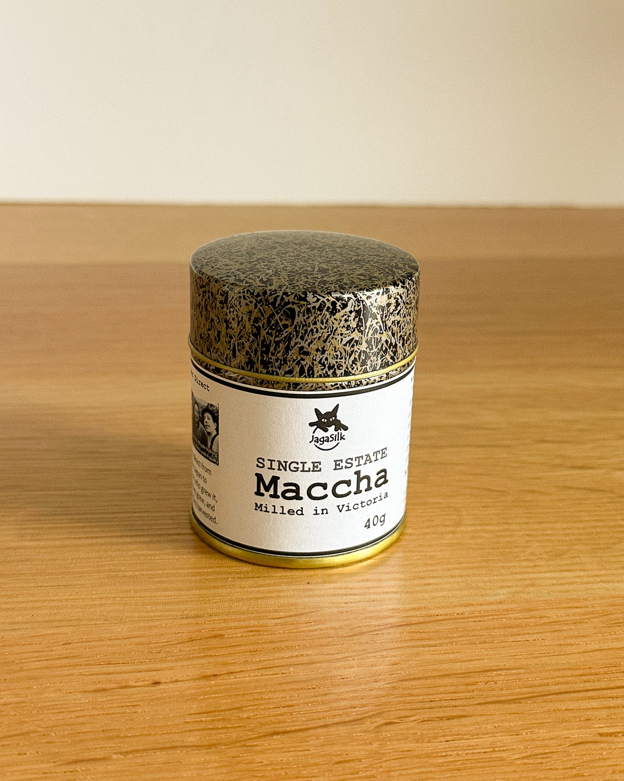 Jar of single estate maccha on a wooden surface