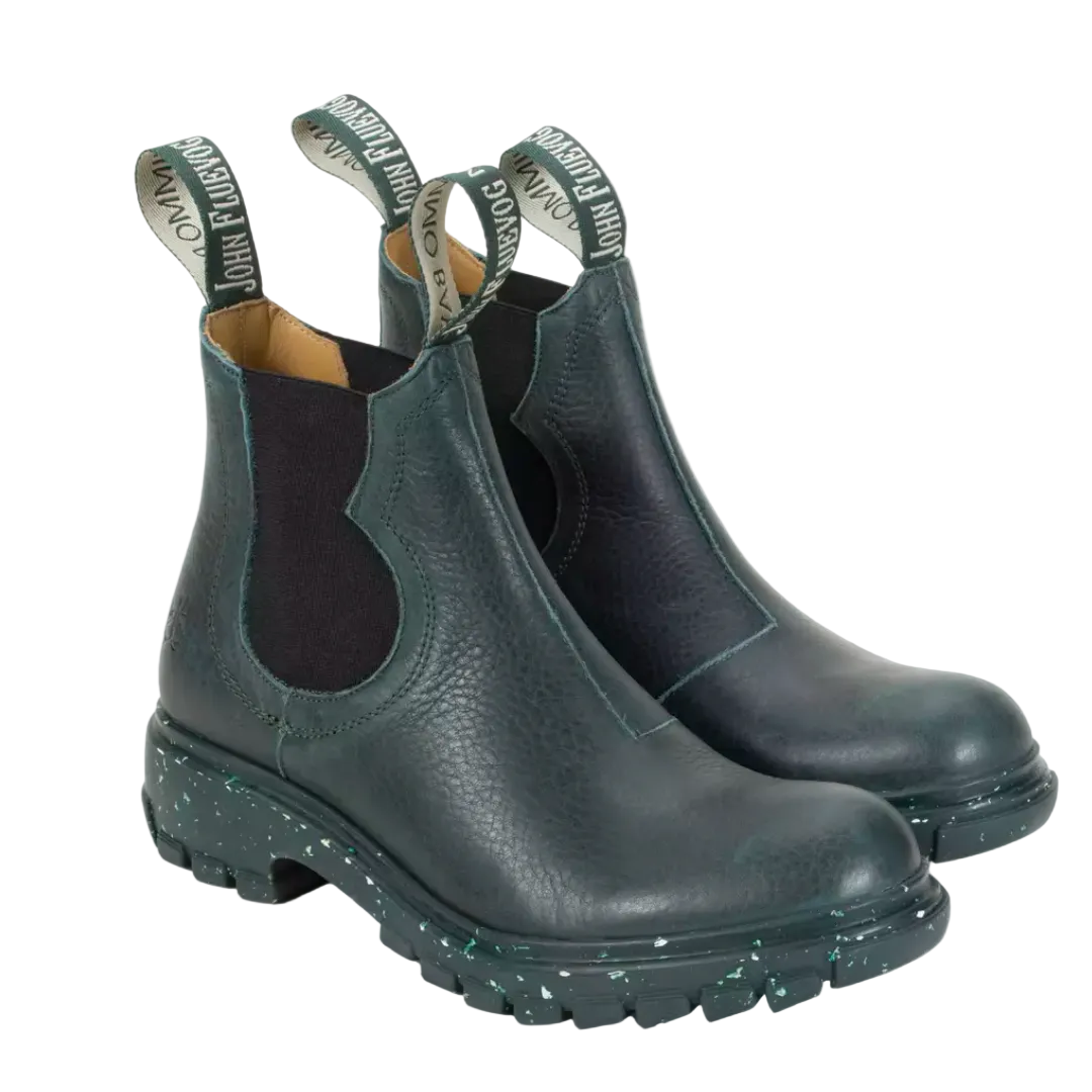 A pair of dark green Fluevog Official Jeudi Chelsea Boots with visible soft leather texture and unique patterned bootlace eyelets.