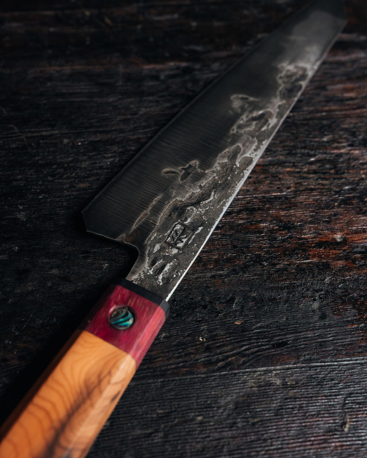 Leechtown Blacksmith Co. chef's knife on black background.