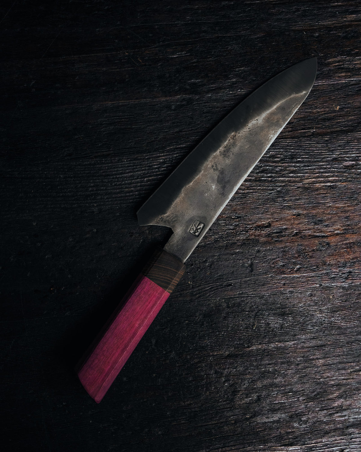 Leechtown Blacksmith Co. chef's knife on black background.