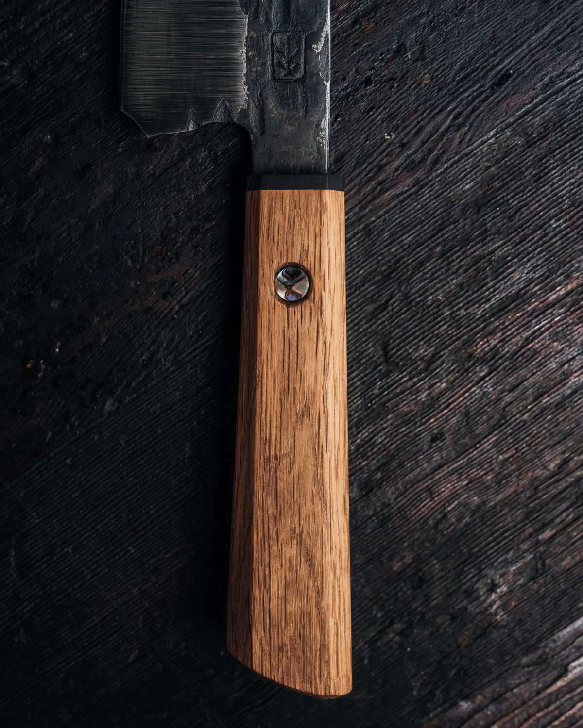 Leechtown Blacksmith Co. chef's knife on black background.