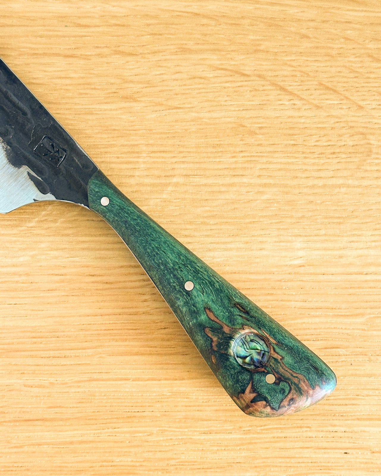 Wooden-handled axe on a wooden surface