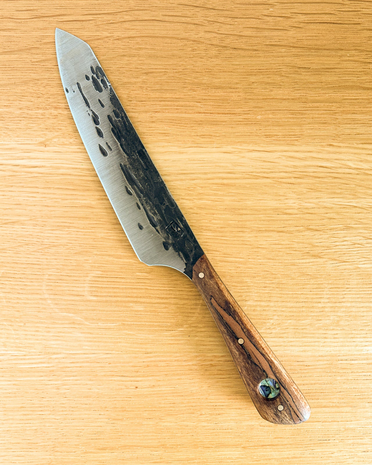 Knife with a wooden handle on a wooden surface