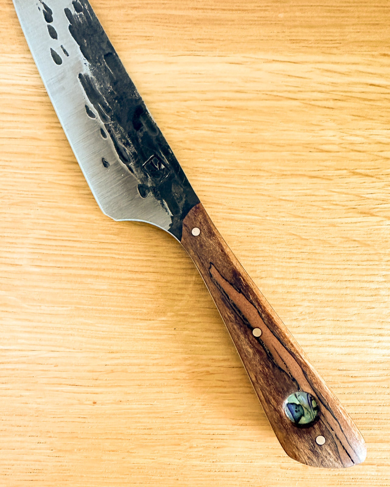 Knife with a wooden handle on a wooden surface