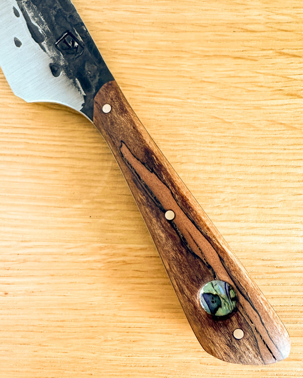 Knife with a wooden handle on a wooden surface