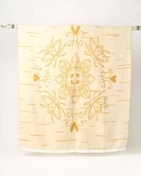 blanketwith gold bee pattern on a white background