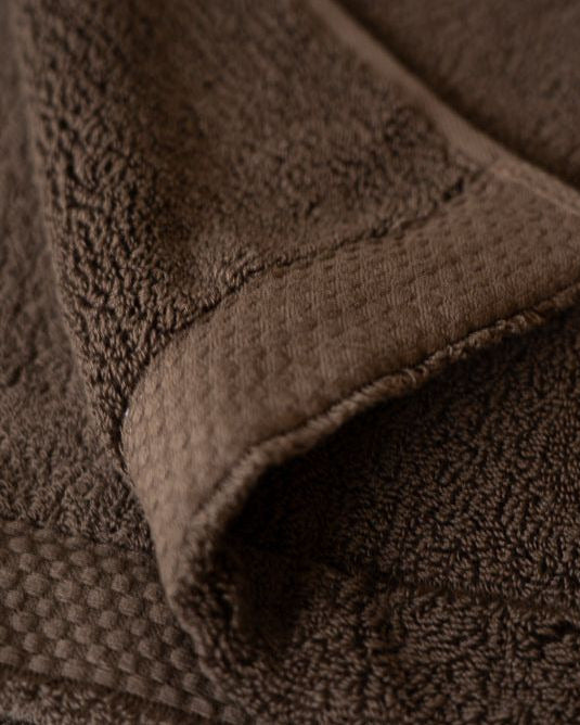 Close-up of a brown textured fabric with a folded corner