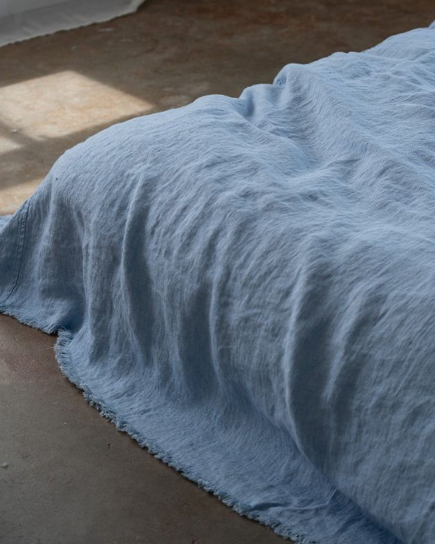 Blue textured fabric on a concrete floor