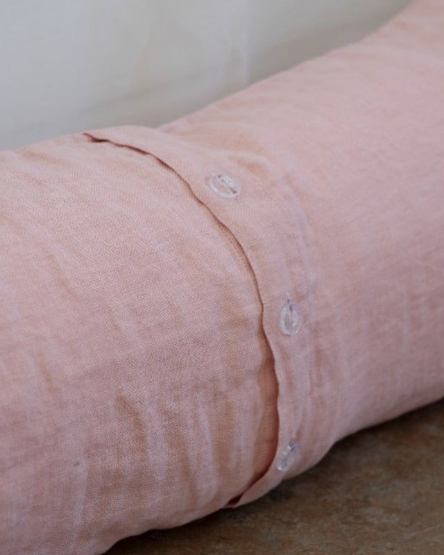 Rolled-up pink shirt sleeve on a white background