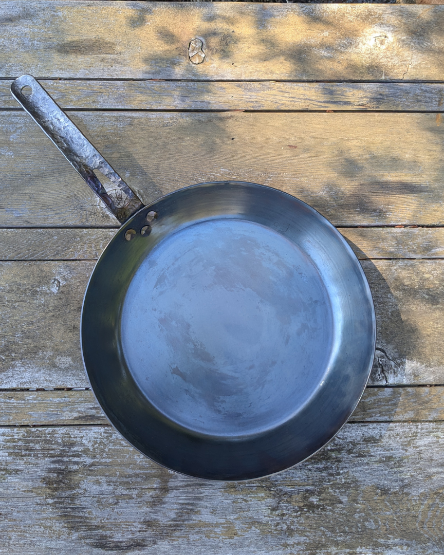 leechtown blacksmith pan lying on a wooden table