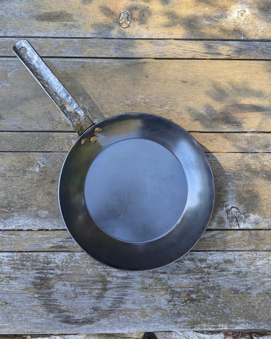 leechtown blacksmith pan lying on a wooden table