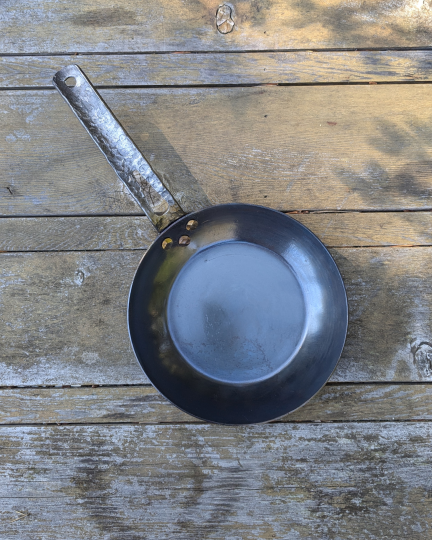 leechtown blacksmith pan lying on a wooden table