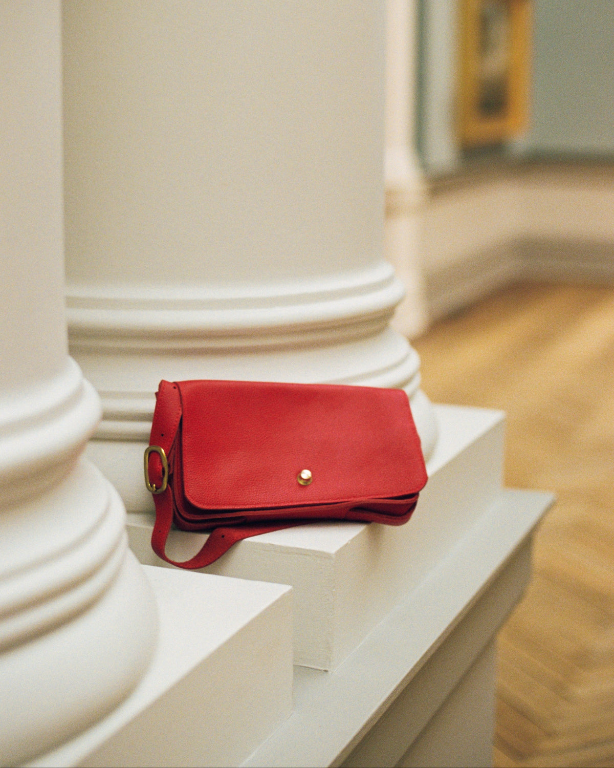 a red purse on a white surface