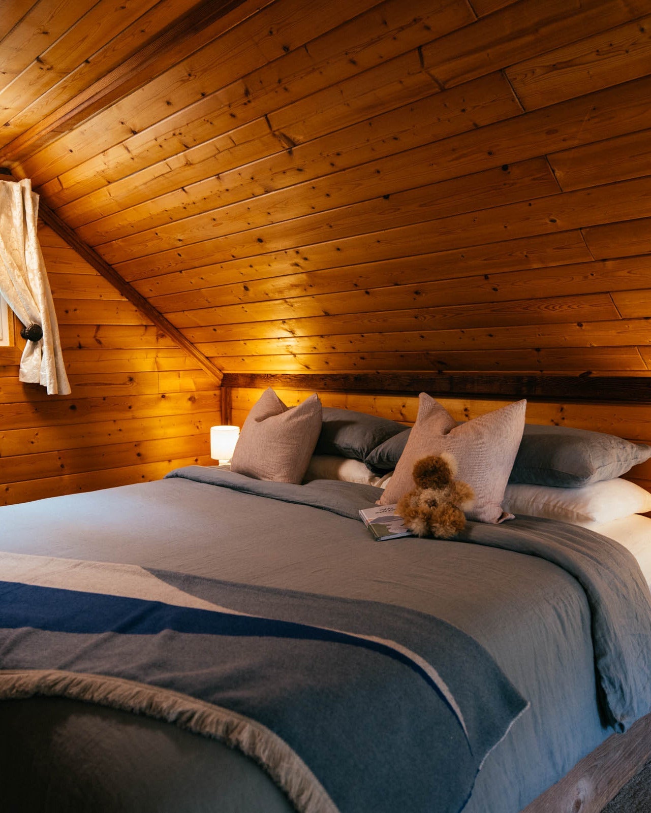nimmo bay cabin with river blanket on bed