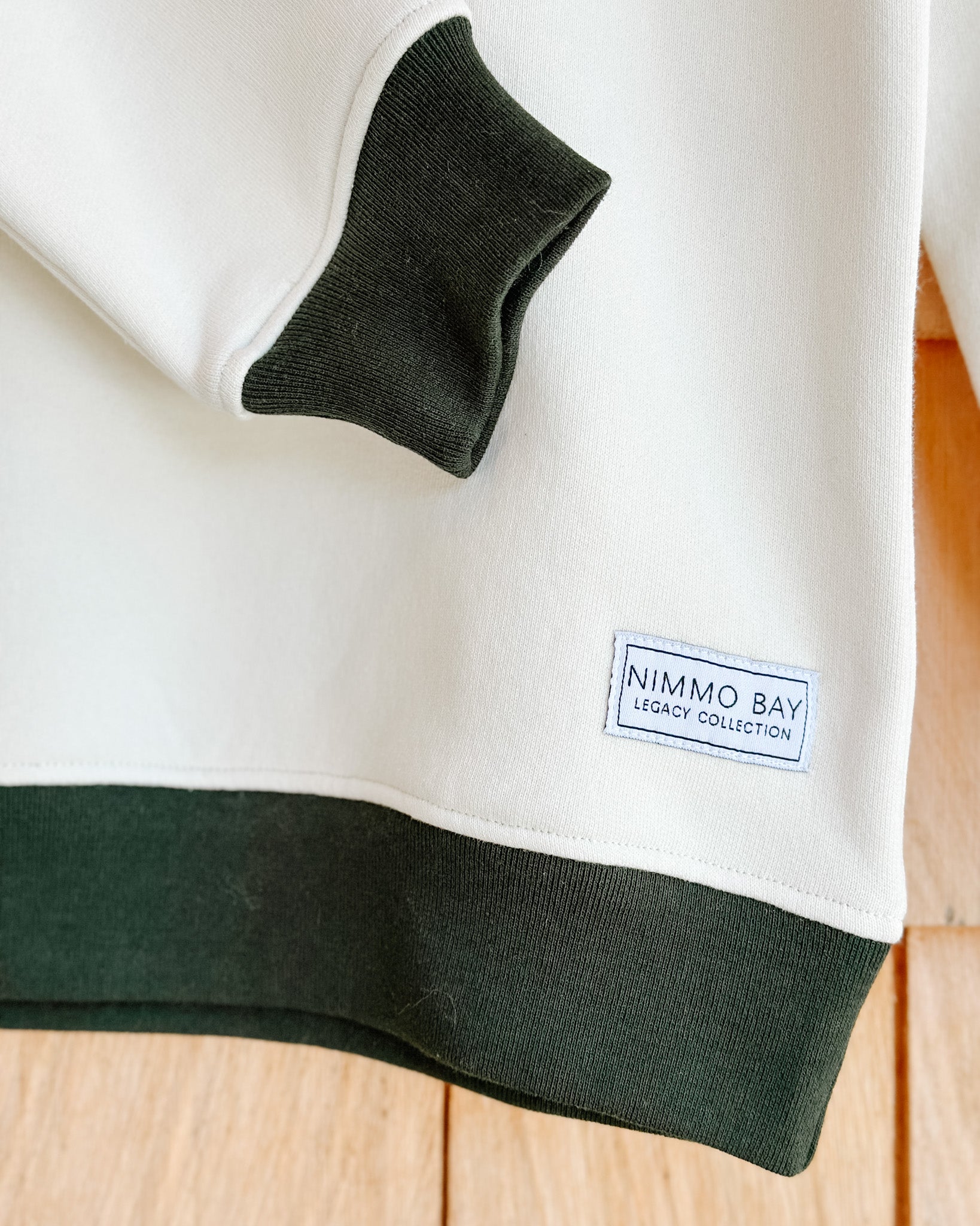 the legacy crewneck sweater from anian in front with nimmo bay legacy collection tag