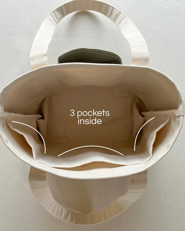 Rather green amiga petite tote bag with three visible pockets on a light gray background