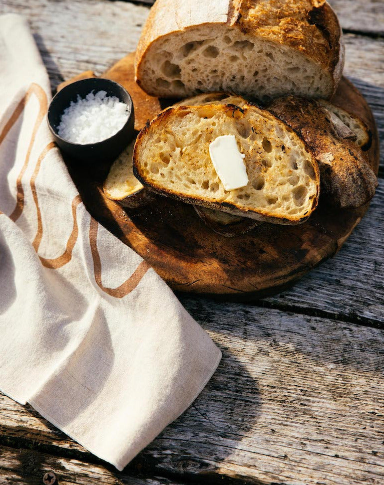copper moons linen napkins with a platter of bread