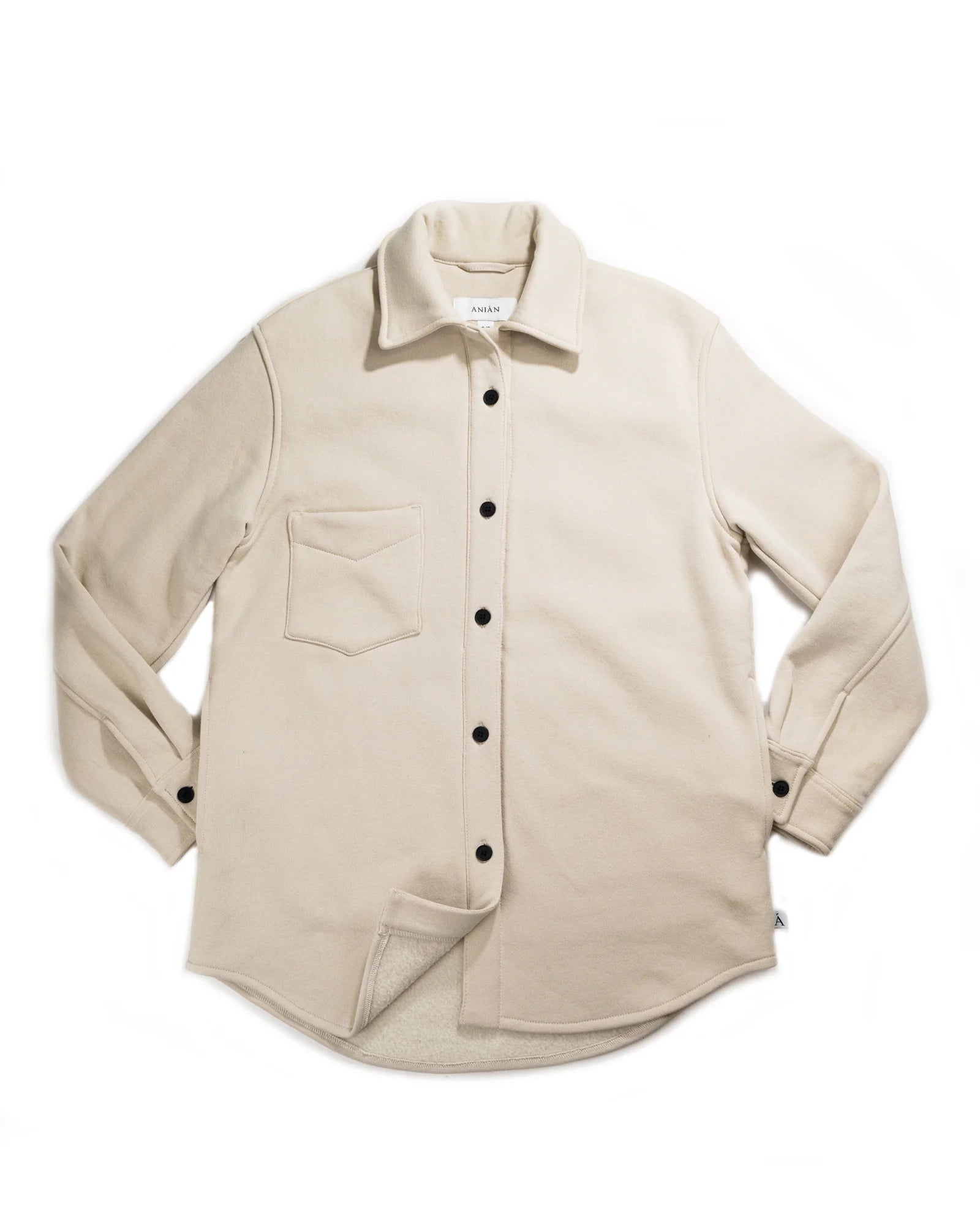 A beige Anian circular jersey shirt with a collar, long sleeves, and button-up front displayed on a white background.