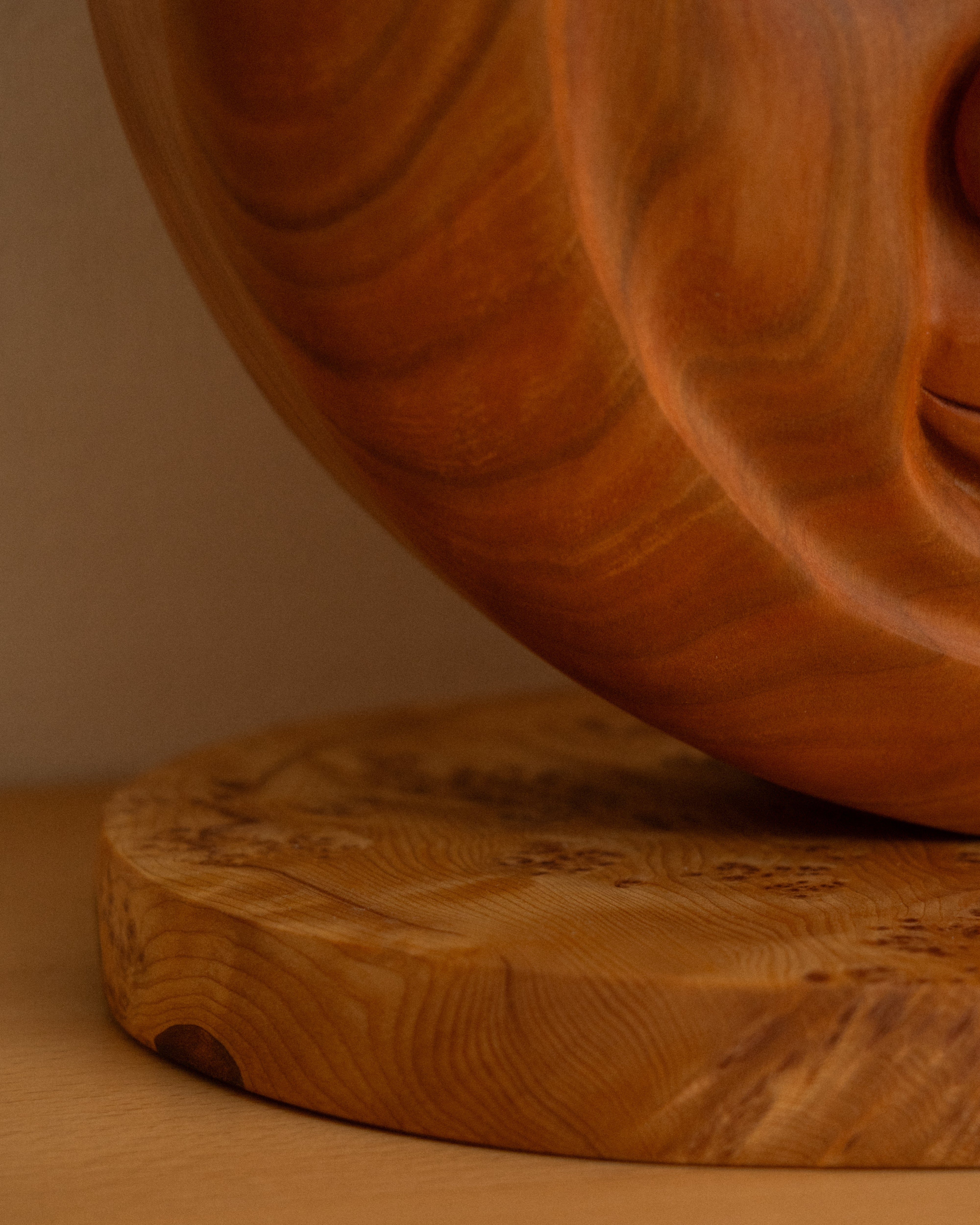 Close-up of a wooden carving on a matching brown background
