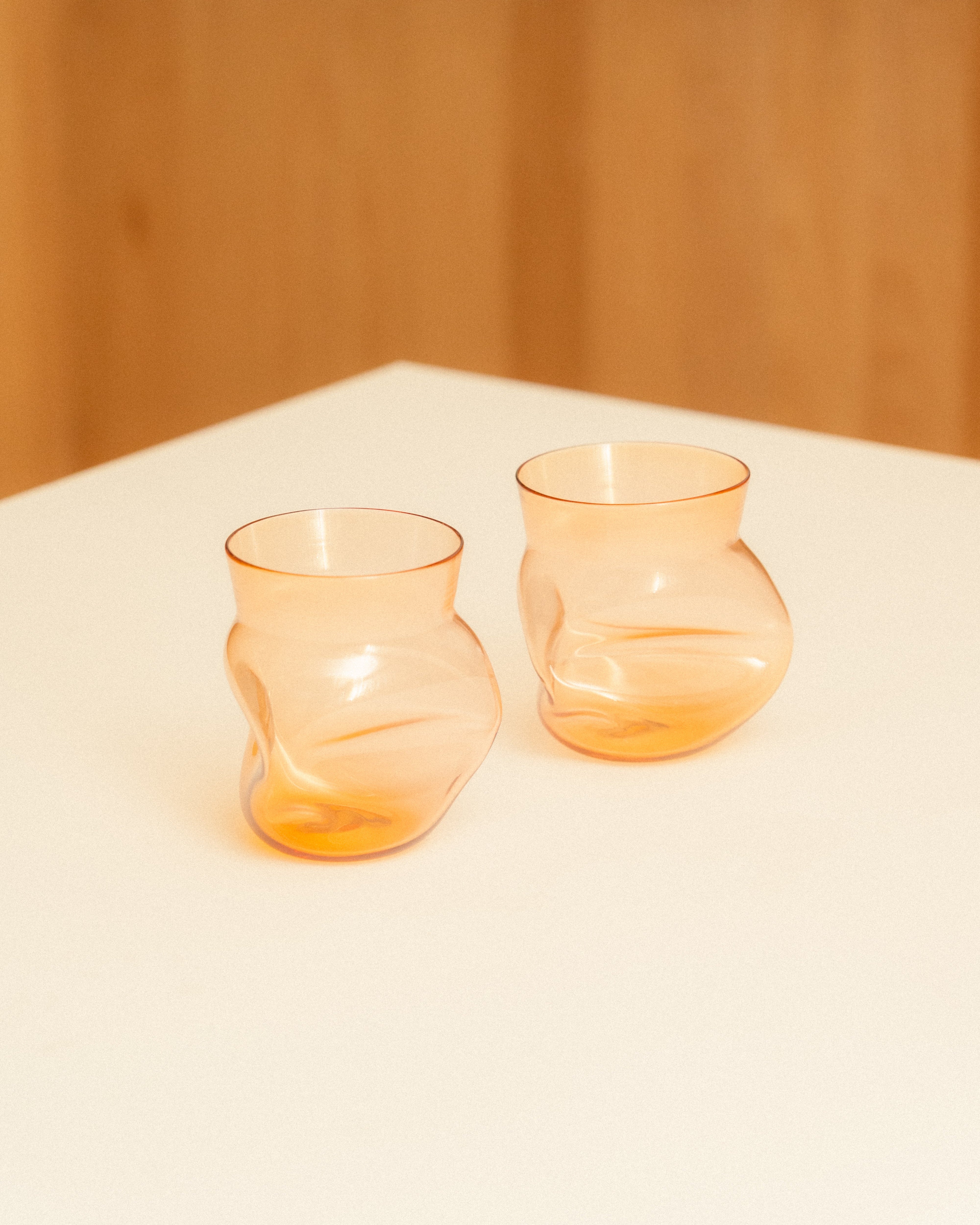 Two Tangerine Goodbeast crushed cups on a table