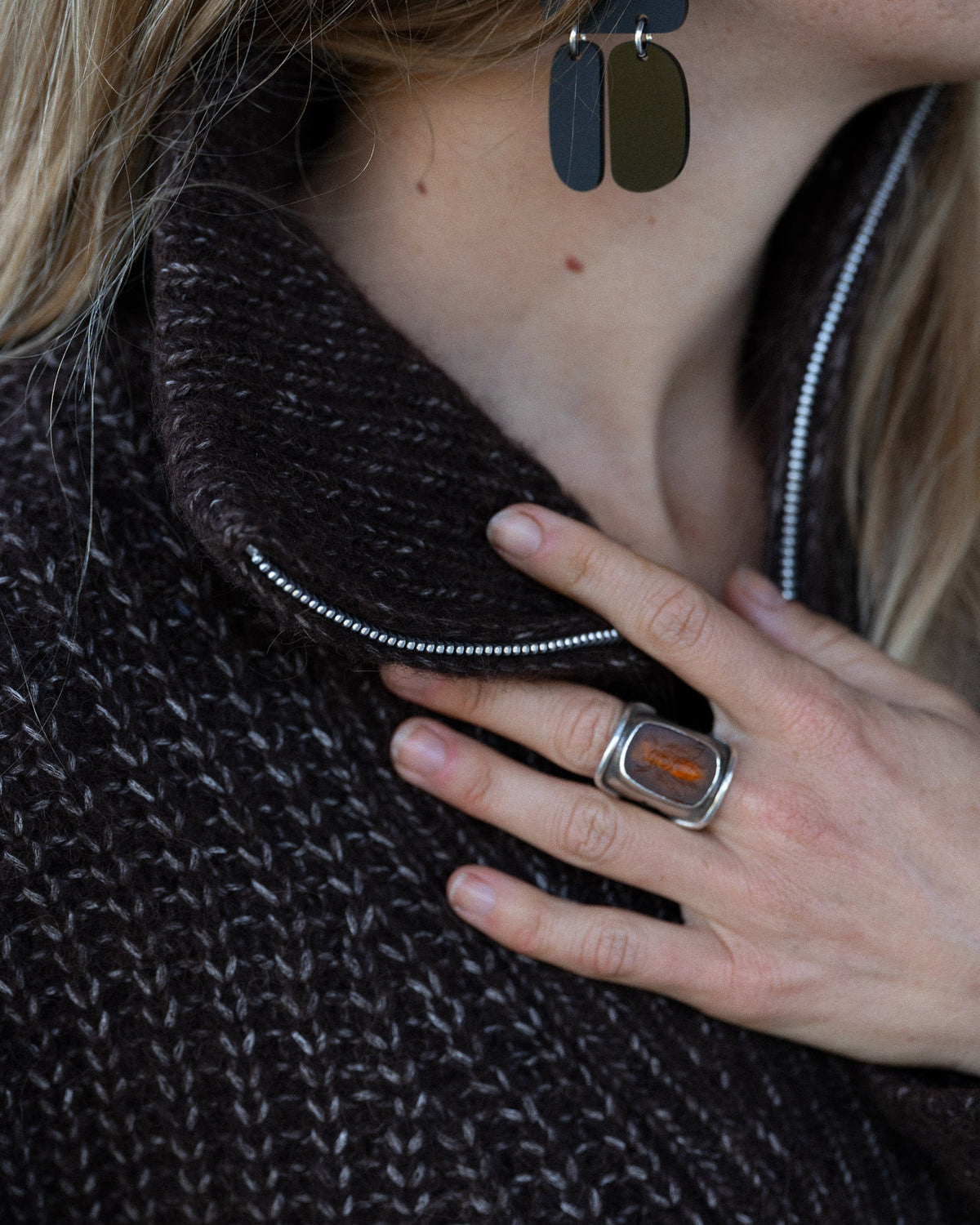 Woman wearing a Bare Knitwear carob brown quarter zip sweater - neckline close up.
