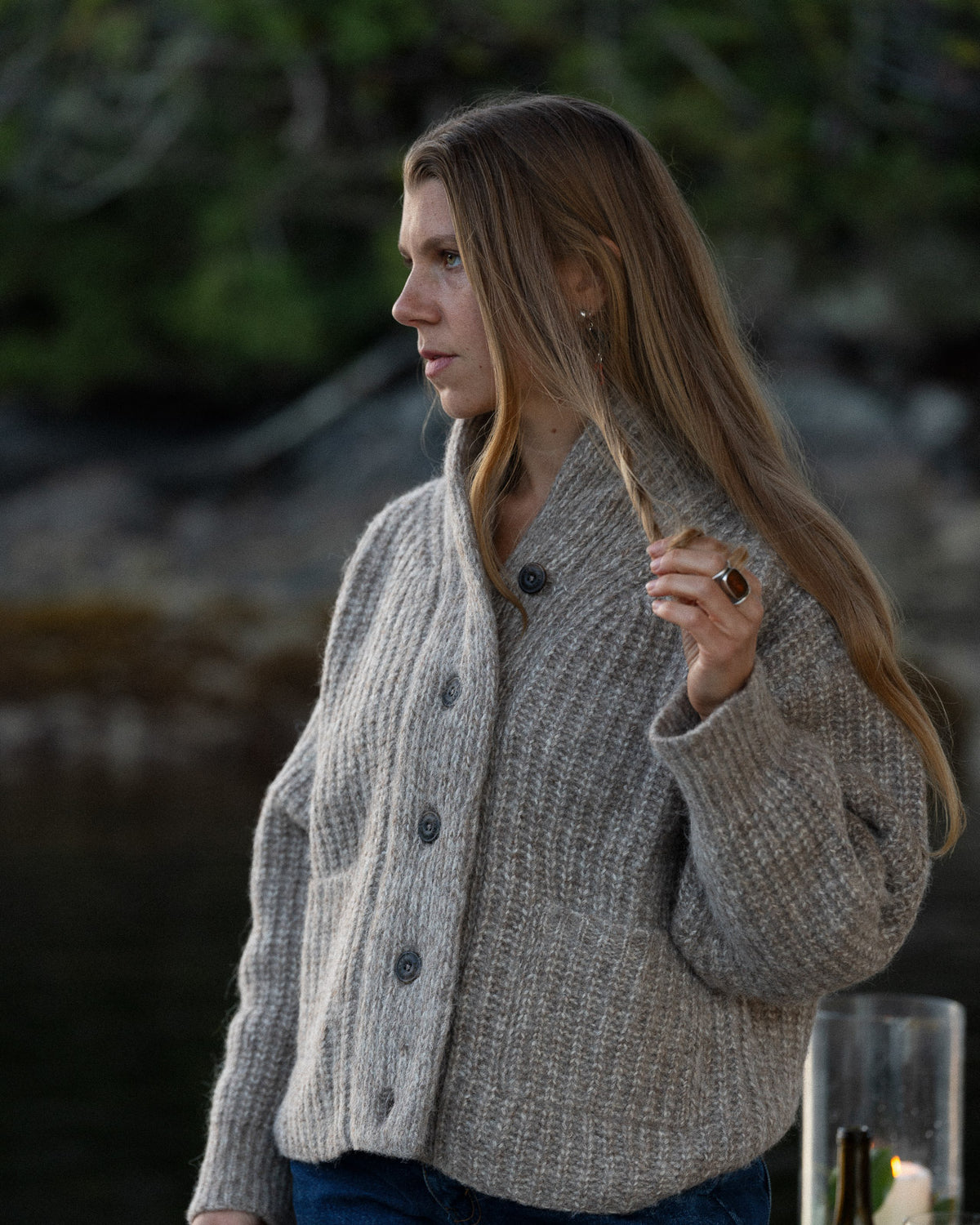 Woman wearing a Bare Knitwear Oversized Shawl Cardigan with a forest background