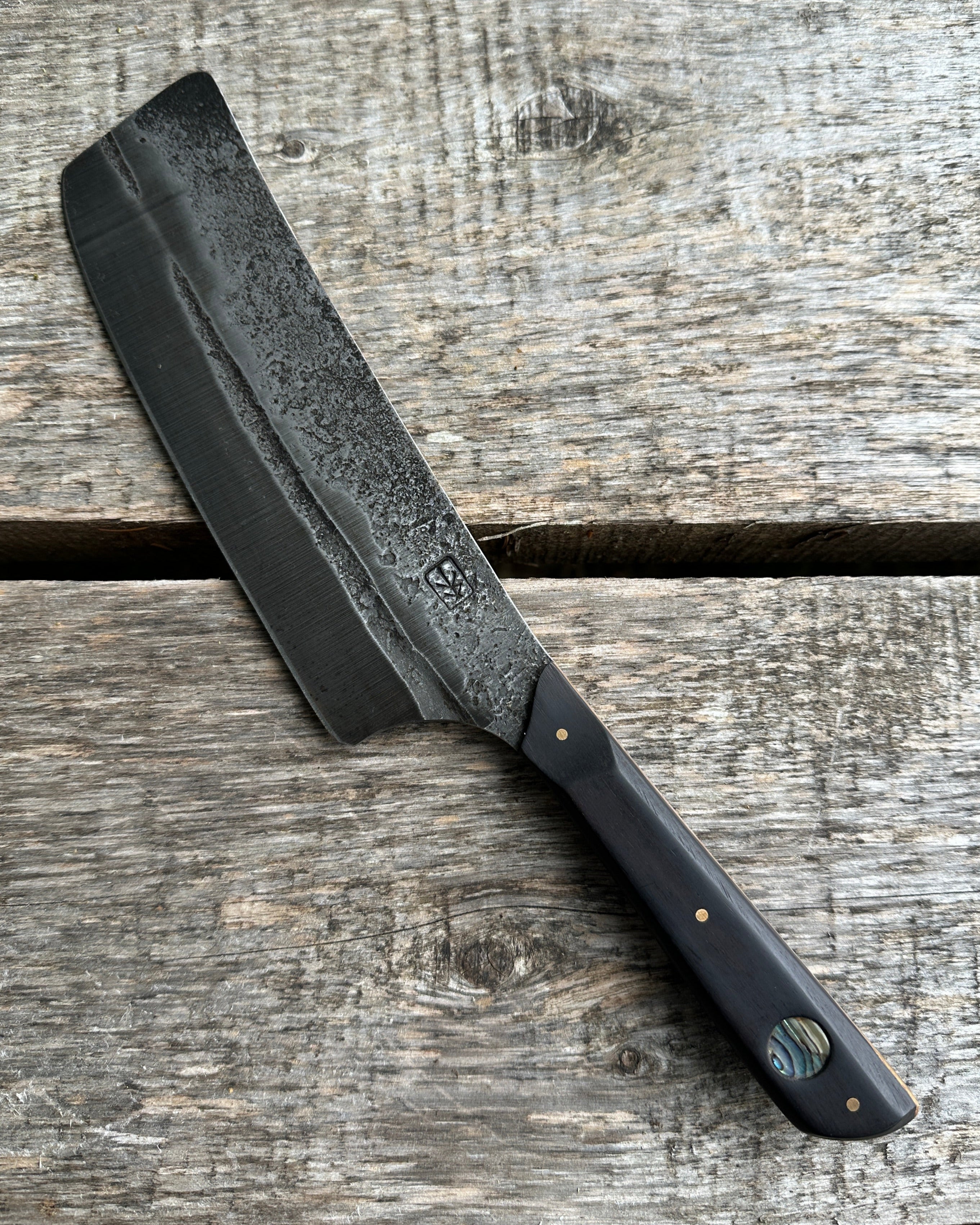 Leechtown Blacksmith Co Black Nakiri knife on a wood background.