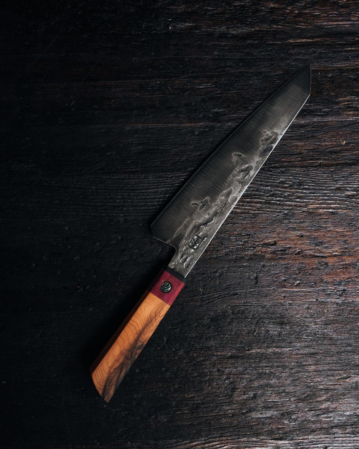 Leechtown Blacksmith Co. chef's knife on black background.