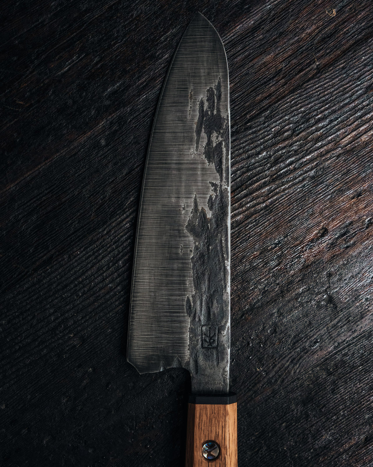 Leechtown Blacksmith Co. chef's knife on black background.