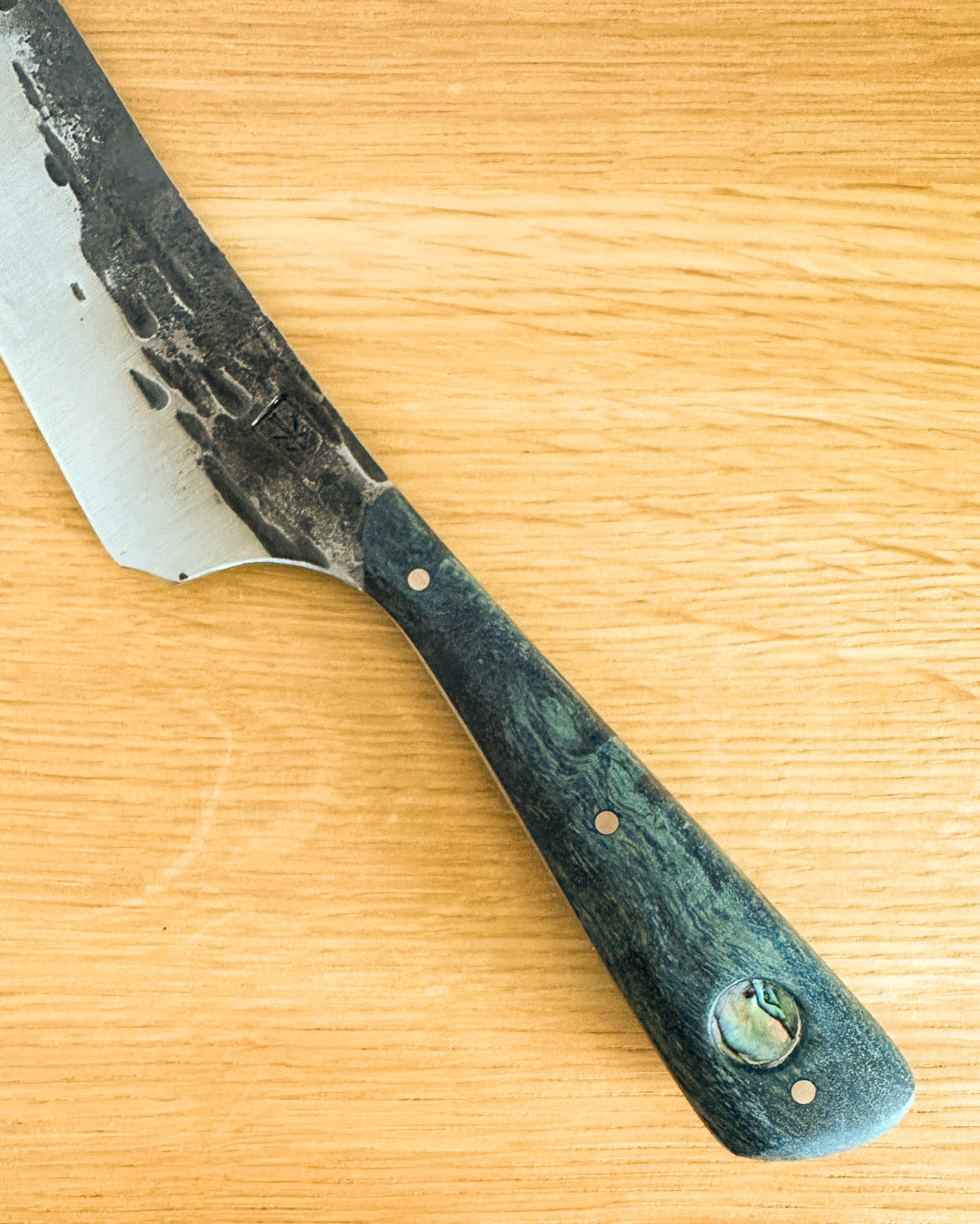 knife with a wooden handle on a wooden surface