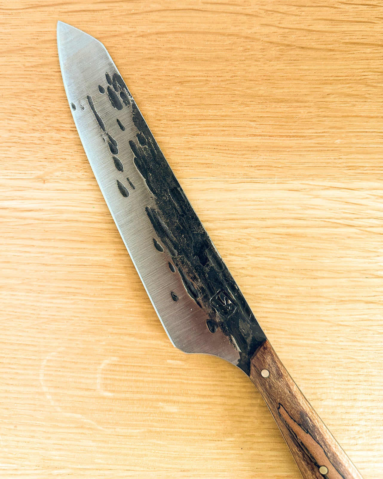 knife with a wooden handle on a wooden surface