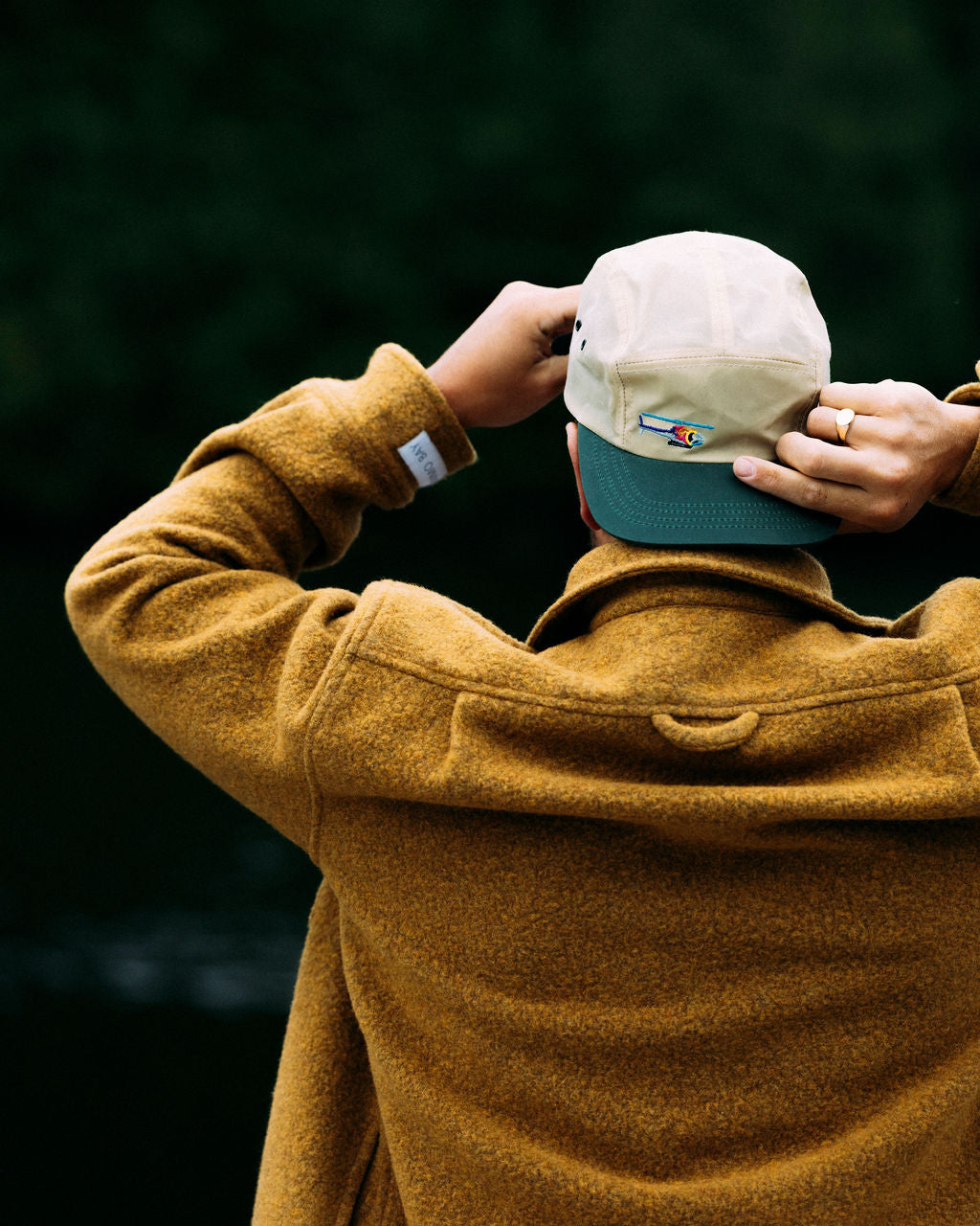 Person wearing a gold anian loft coat and beige nimmo bay legacy hat