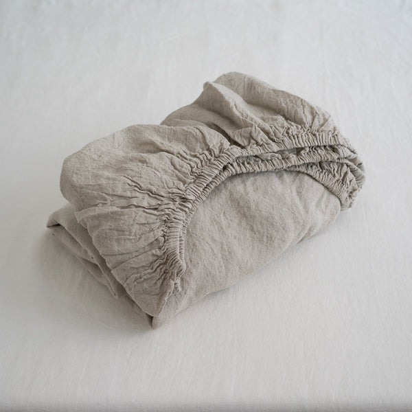 Folded beige fabric on a white background
