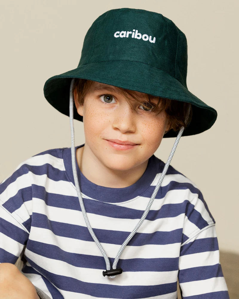 a child wearing a green bucket hat