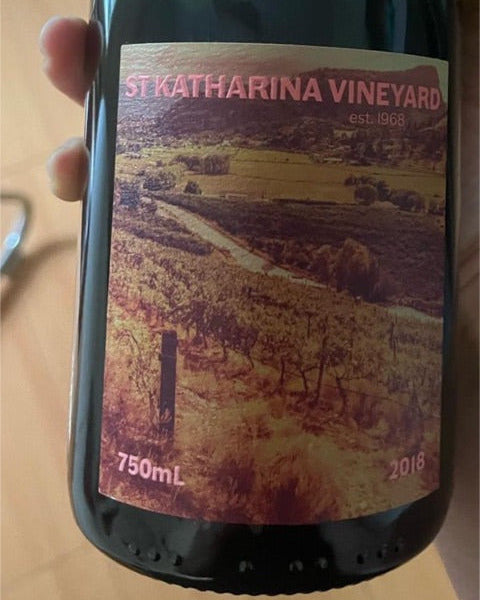 Wine bottle with St Katharina Vineyard label held by a hand