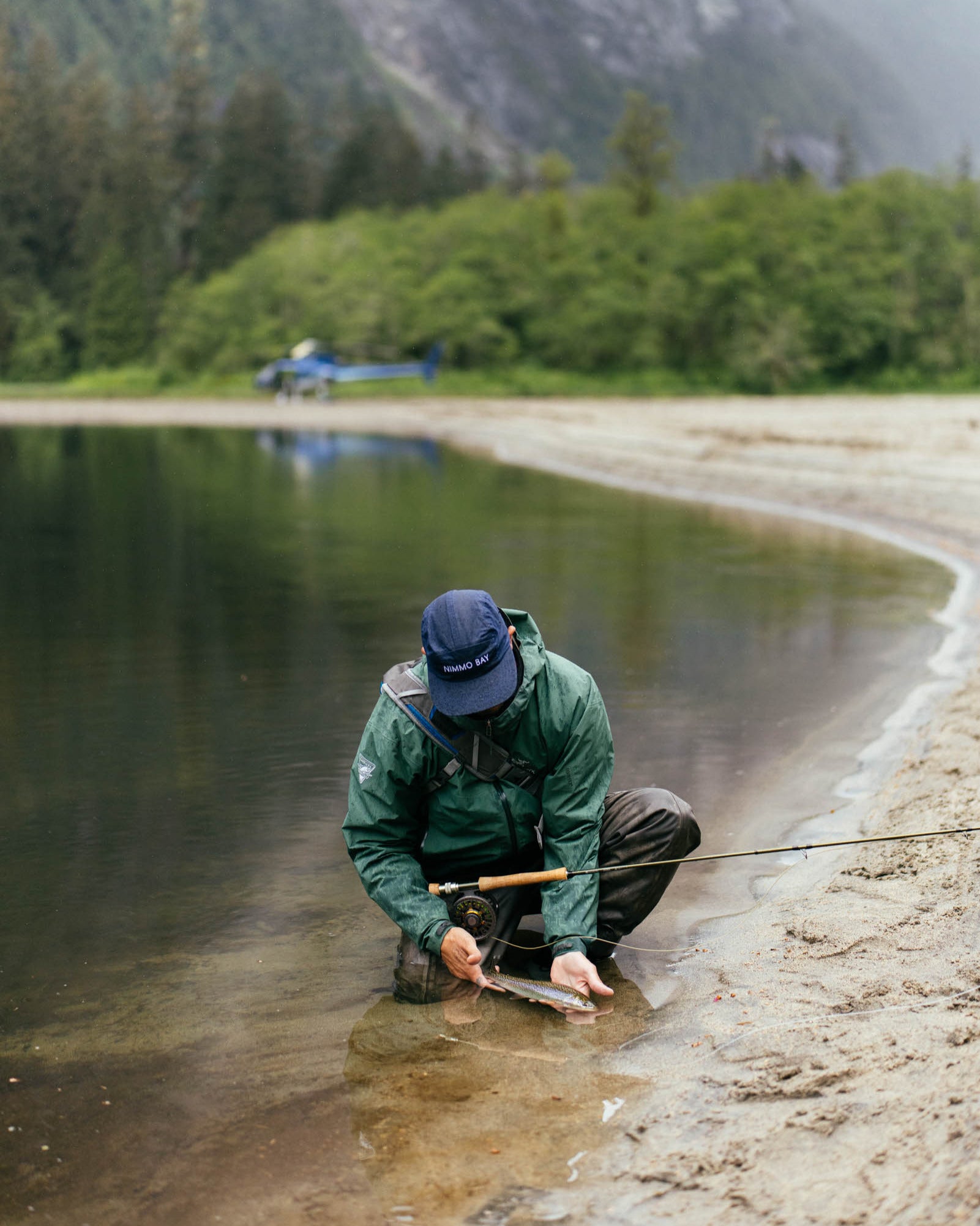 man displaying fish after fly fishing